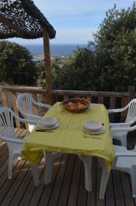 a table with a bowl of fruit on a deck at chez Jean-Marc in Lumio