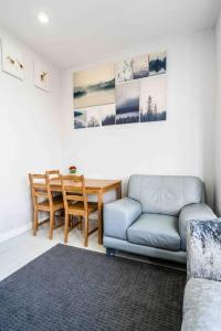 a living room with a couch and a table at Modern flat in Moseley with Free Parking in Birmingham