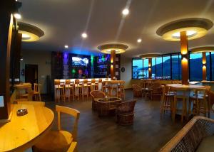 a restaurant with tables and chairs and a bar at Hotel Glory Garden in Pokhara
