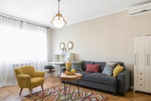 uma sala de estar com um sofá e uma mesa em Central Park Apartments em Belgrado