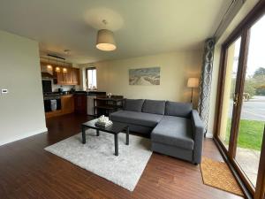 a living room with a couch and a table at Donard Point in Newcastle