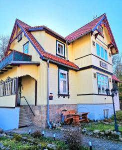 una casa amarilla con techo rojo en Haus Fessel - Birkenkopf en Elend