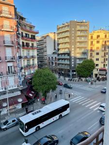 a bus on a city street with cars and buildings at Hotel Kastoria in Thessaloniki