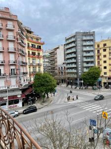 a city street with cars and people crossing the street at Hotel Kastoria in Thessaloniki