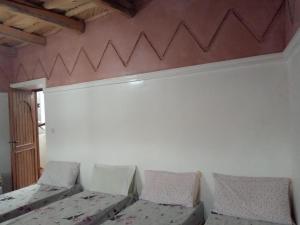 A bed or beds in a room at Gîte Assafar