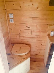 a wooden sauna with a wooden toilet in it at Roulotte Un temps pour soi in Bérat