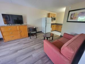 a living room with a couch and a television at Studio 9 Inn & Suites in Decatur