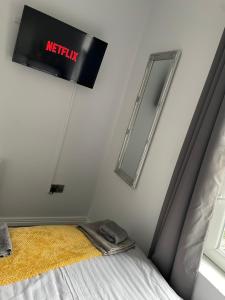 a sign on a wall above a bed in a room at Harvey Apartments in Derry Londonderry