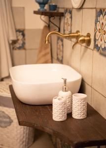 a bathroom sink and two rolls of toilet paper on a table at Trulli Magnolia in Putignano