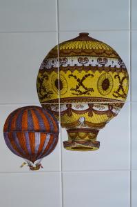 a vase and a balloon hanging on a wall at Peppe's house in Gravina di Catania