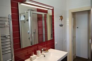 a bathroom with a sink and a mirror at Peppe's house in Gravina di Catania +20 photos