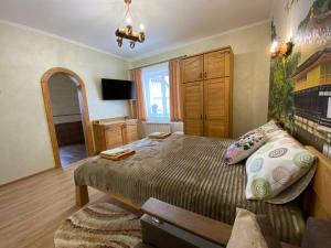 a bedroom with a large bed and a mirror at Villa OkSun in Skhidnitsa