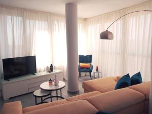 salon z kanapą i telewizorem w obiekcie Skyline Suites Costa del Sol w mieście Torremolinos
