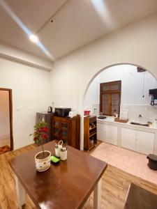 a large kitchen with a wooden table and a table sidx sidx sidx at THE APARTMENT in Gangtok +12 photos