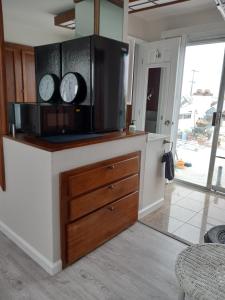 a kitchen with two clocks on top of a counter at SHARED TOWNHOUSE in MISSION BEACH in San Diego