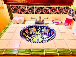 a bathroom sink with a blue and white at Casa Biulú in Zipolite