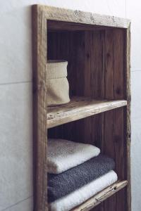 a wooden shelf with towels on a wall at Padaster 1262 in Trins
