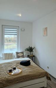 a bedroom with a bed with a tray on it at Apartament Czechowska Comfort in Lublin