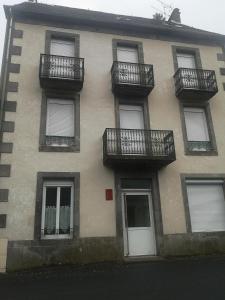 a building with balconies on the side of it at Appartement idéalement situé in Le Mont-Dore