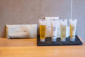 a group of four bottles of sunscreen sitting on a table at Casa Bodhi Boutique Hotel & Spa in Marbella