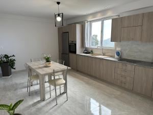 a kitchen with a table and chairs in a room at Angel Homes in Plakias