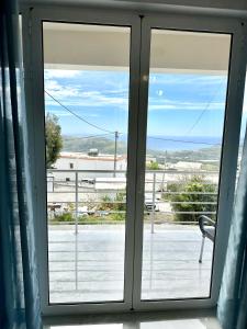 a window with a view of a patio at Angel Homes in Plakias