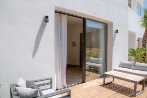 a patio with a couch and a table at Casa Bodhi Boutique Hotel & Spa in Marbella