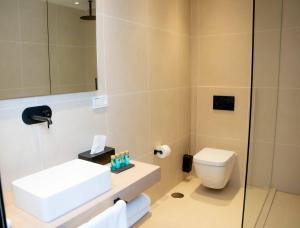 a bathroom with a white sink and a toilet at Casa Bodhi Boutique Hotel & Spa in Marbella