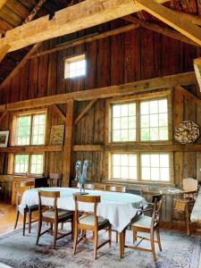 a dining room with a table and chairs in a barn at Historic Renovated Barn at Boorn Brook Farm - Manchester Vermont in Manchester Center