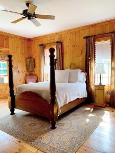 a bedroom with a bed and a ceiling fan at Historic Renovated Barn at Boorn Brook Farm - Manchester Vermont in Manchester Center