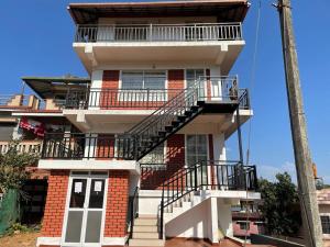 un edificio con una escalera en el lateral en SERENITY GREENS en Madikeri