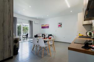 a kitchen and living room with a table and chairs at Aleanna Cozy Luxury Apartments in Rhodes Town