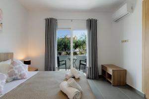 a bedroom with a bed and a table with a view at Aleanna Cozy Luxury Apartments in Rhodes Town