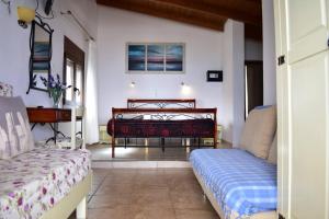 a bedroom with two beds and a table at Marinakis Sea View Studios in Sougia