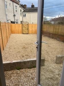 an open door to a yard with a fence at Small room in Horfield 3 in Bristol