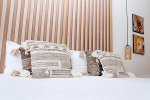 a bed with two blankets and pillows on it at Casa Bodhi Boutique Hotel & Spa in Marbella