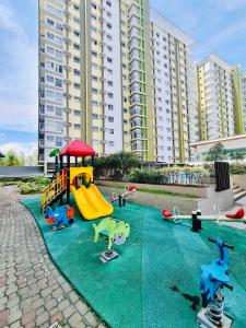 a playground with play equipment on a green carpet at Spacious Combine Family Unit Condo at Mesaverte Residences downtown near SM Gaisano Robinson and Centrio in Cagayan de Oro