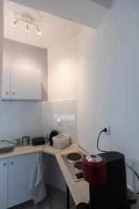 a kitchen with a stove and a counter top at Όμορφο στούντιο στο κέντρο της πόλης. in Larisa +5 photos