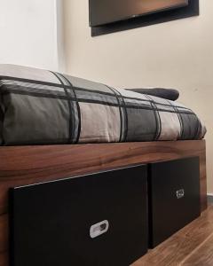a mattress sitting on top of a wooden bed at The Liverpool Pod Travel Hostel in Liverpool