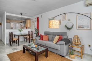 a living room with a couch and a table at La Duquesa apartment with pool Ref M8 in Manilva