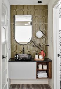 a bathroom with a sink and a mirror at Midcentury Couples Designer Loft - Casa Tuya in Austin