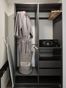 a walk in closet with a towel and a microwave at Midcentury Couples Designer Loft - Casa Tuya in Austin