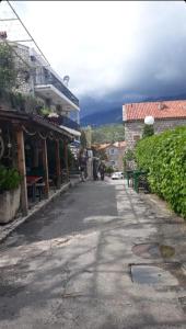 an empty street in a town with a building at Apartments Baka in Pržno