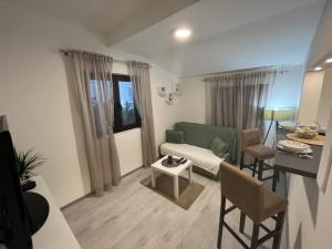 a living room with a couch and a table at Apartments Baka in Pržno
