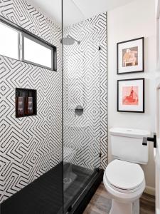 a bathroom with a toilet and a shower at Midcentury Couples Designer Loft - Casa Tuya in Austin