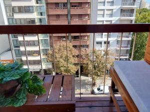 a balcony with a bench and a view of a building at Departamento completo para 2 personas - Esquina Plaza Mitre in Mar del Plata +53 photos