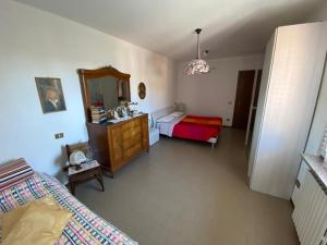 a bedroom with a bed and a dresser and a mirror at Gloria's house in Zerbolò