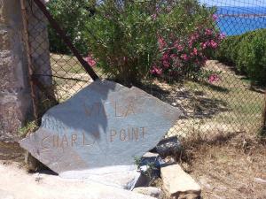a sign that says villa chapel point on a fence at Charly Point Villa in Methoni
