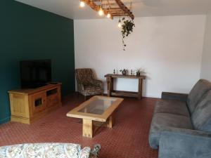 a living room with a couch and a coffee table at Chez Henri in Les Herbiers