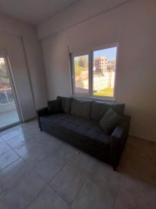 a living room with a couch and two windows at Avsallar Star Residence in Avsallar